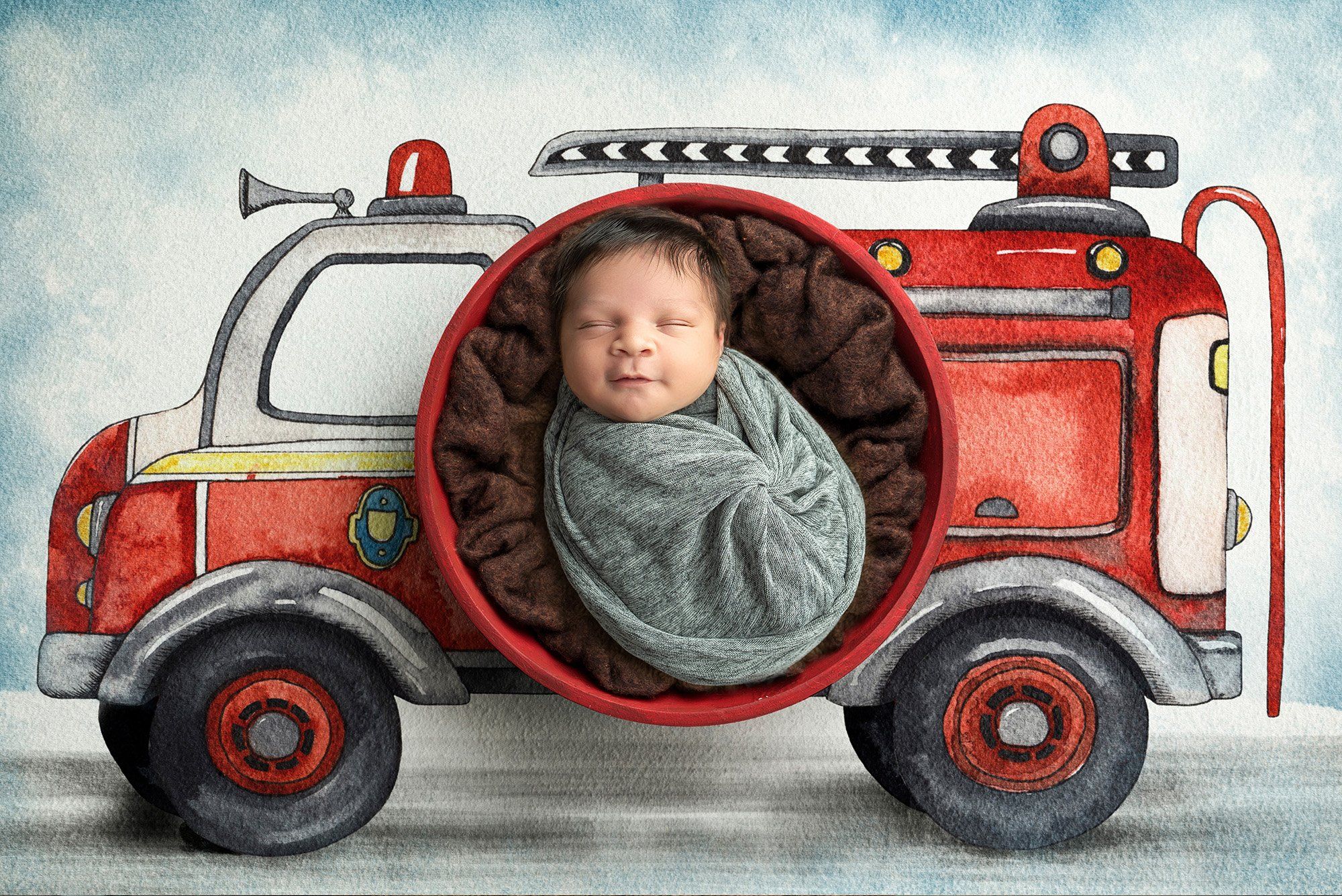 newborn baby boy happily smiling while sleeping swaddled in gray with fire truck background