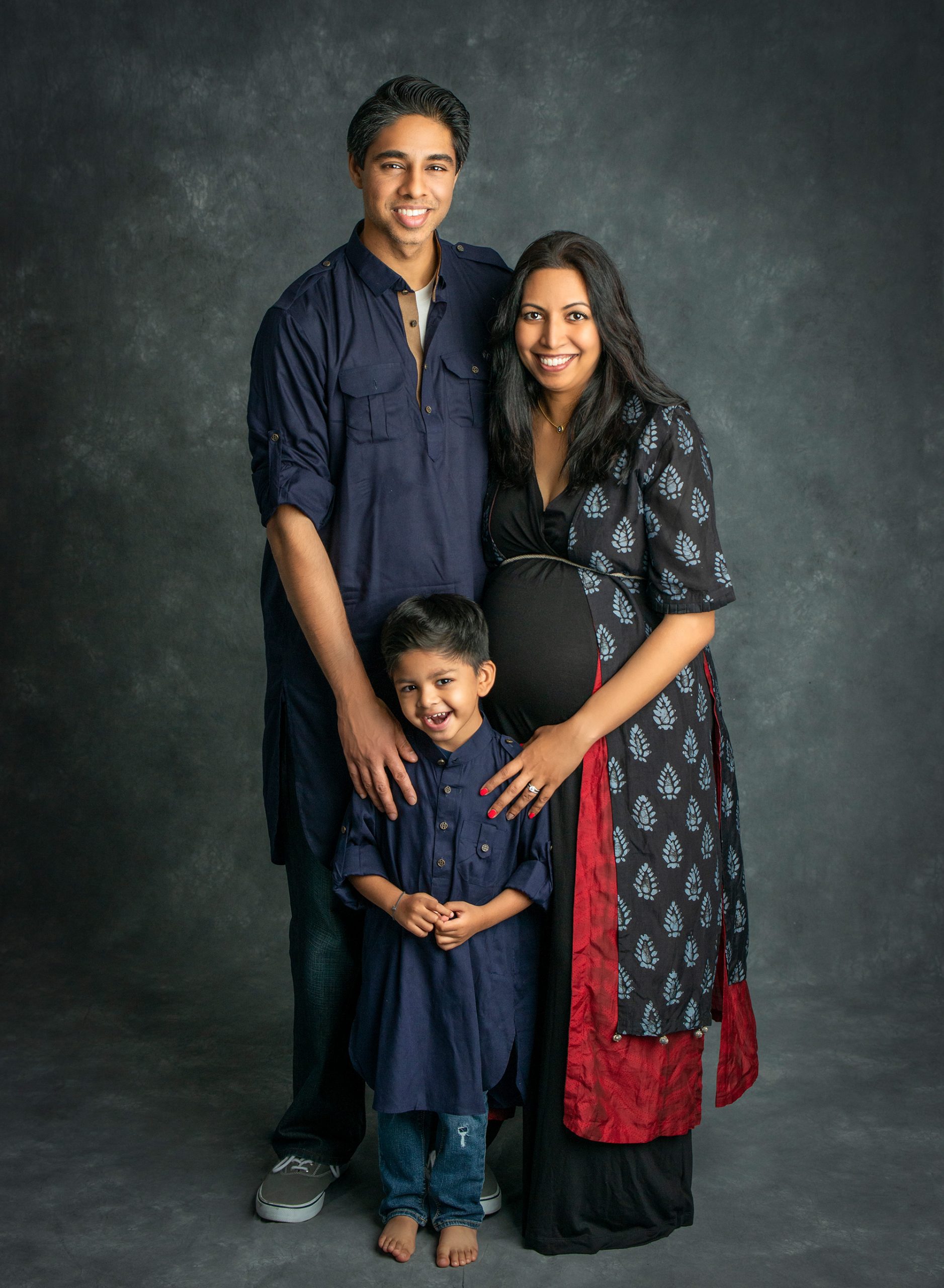 Family Maternity Photos pregnant woman posing with husband and smiling young son