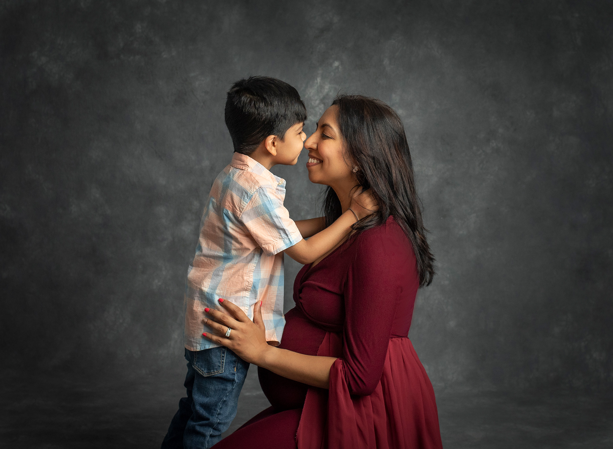 Family Maternity Photos pregnant mother giving butterfly kisses to young son