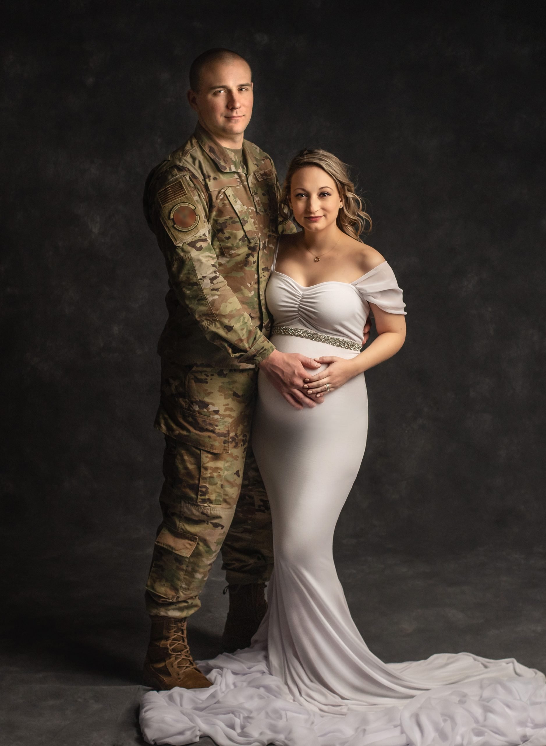 man in Air Force Uniform and his pregnant wife in maternity photograph
