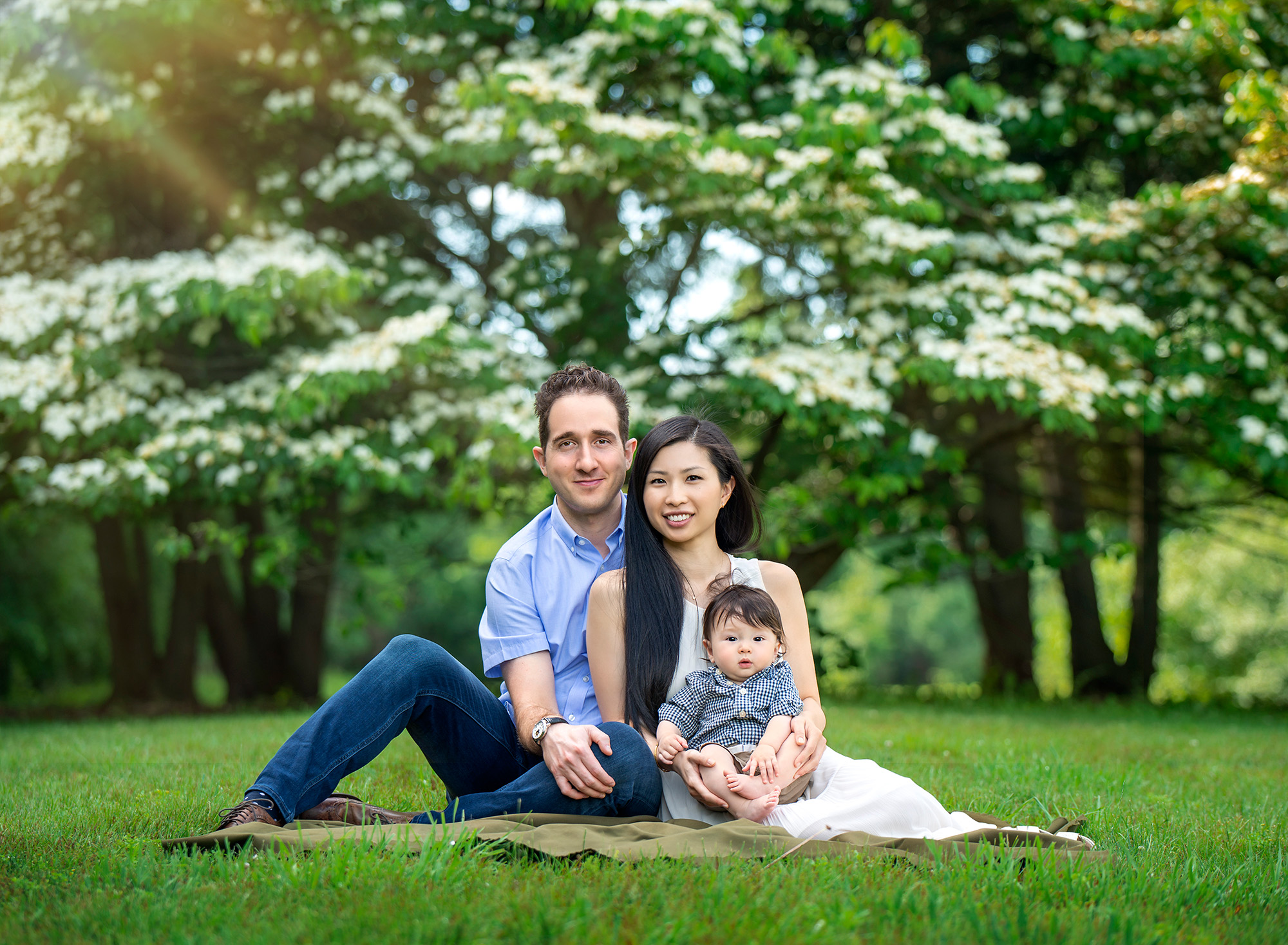 Springtime 6-month Baby Photos couple sitting in the grass with toddler son