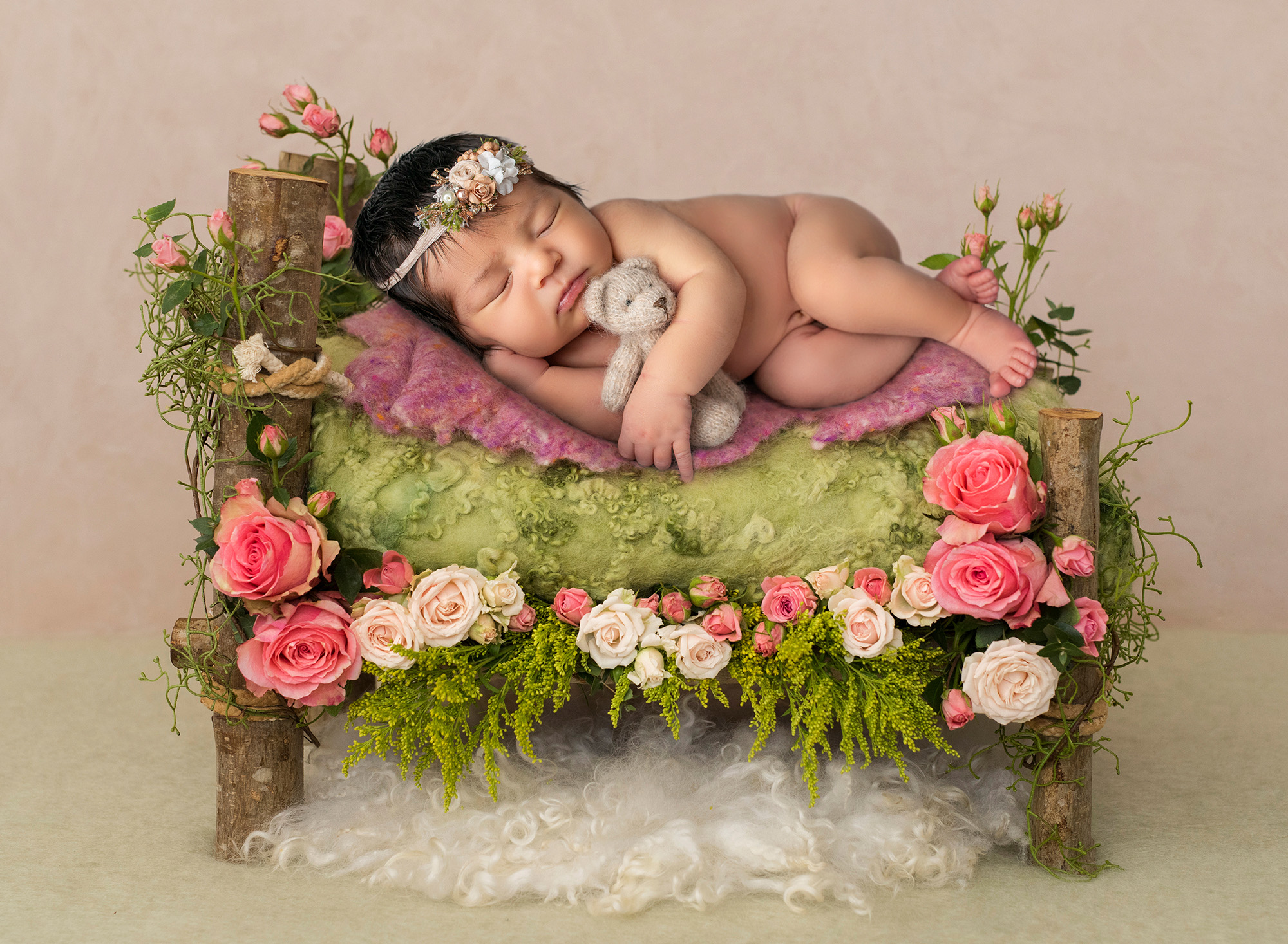 newborn photographer in CT baby girl sleeping on bed of roses