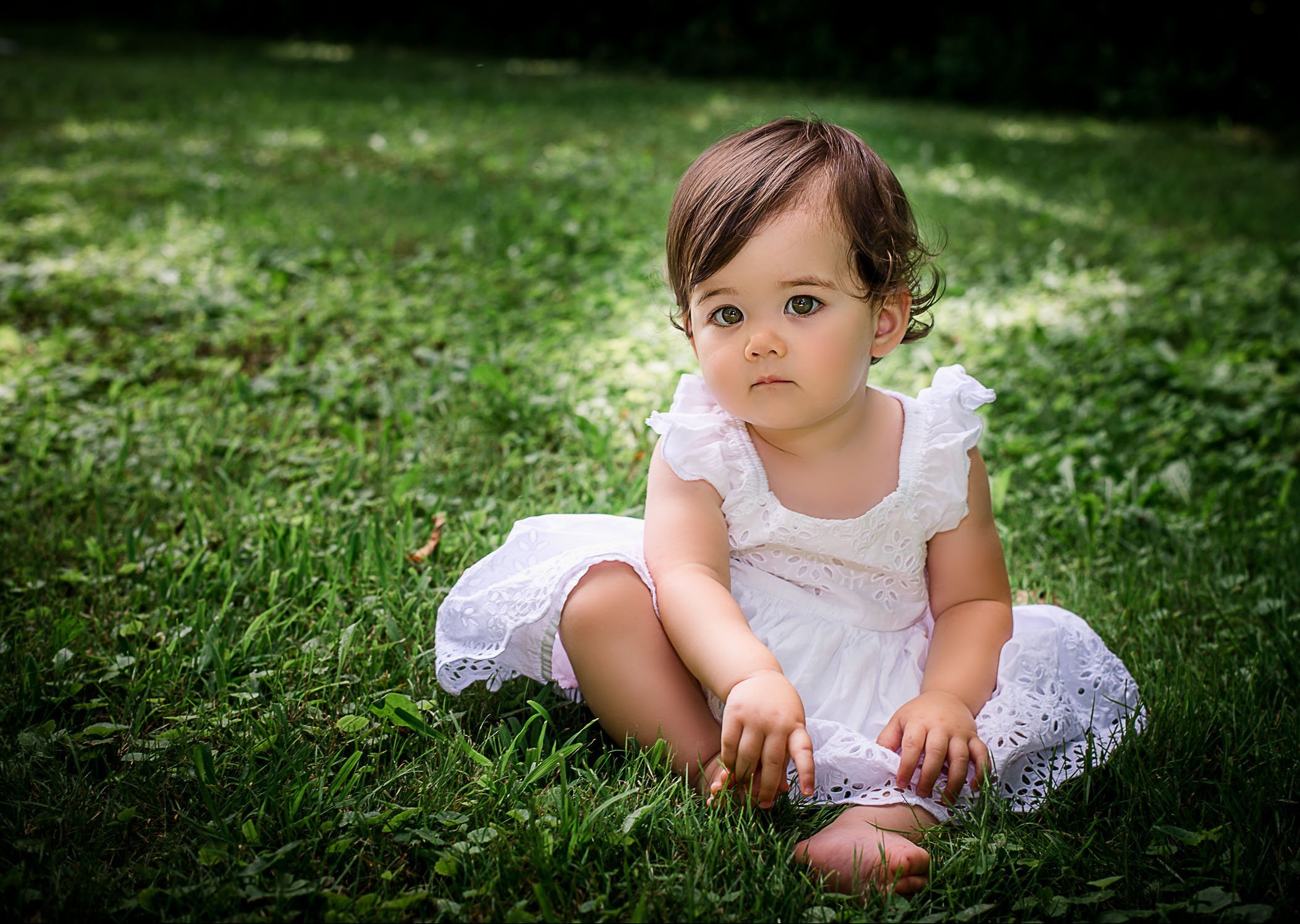 one year old baby girl photos sitting in grass looking at camera One Big Happy Photo